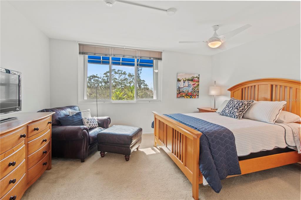 829 Bayport Way, Unit 829 Longboat Key, FL 34228 - Photo 27 of 58 a bedroom with a bed and a couch