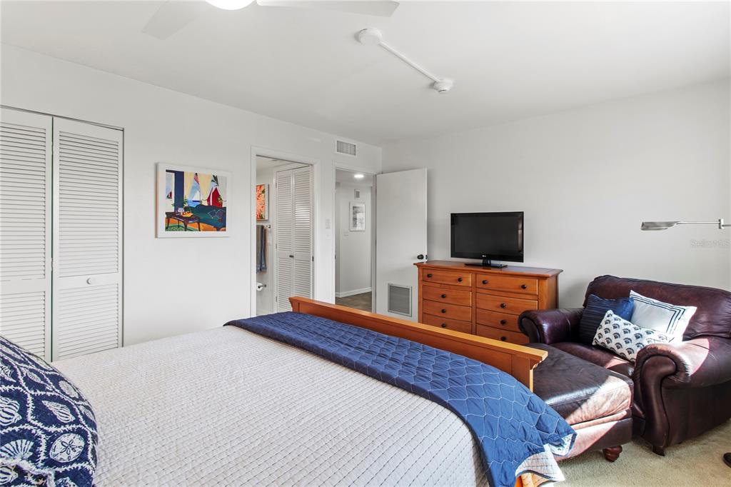 829 Bayport Way, Unit 829 Longboat Key, FL 34228 - Photo 28 of 58 a bedroom with a bed and a television