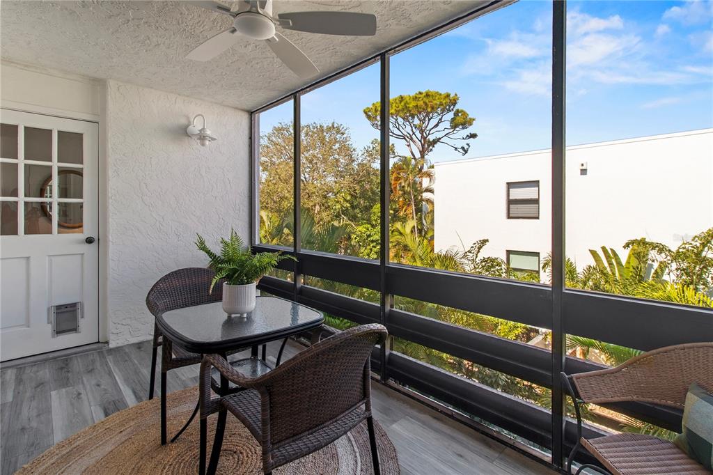 829 Bayport Way, Unit 829 Longboat Key, FL 34228 - Photo 30 of 58 a view of a balcony with chairs and a potted plant