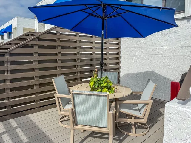 a view of a hallway and an dining room with furniture