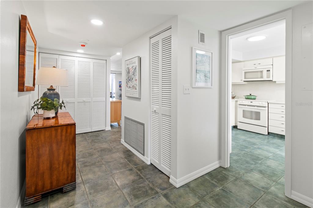 829 Bayport Way, Unit 829 Longboat Key, FL 34228 - Photo 6 of 58 a view of a hallway and an dining room with furniture