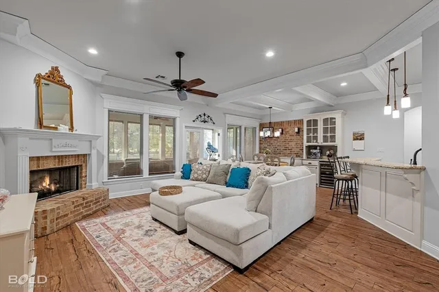a living room with furniture fireplace and window