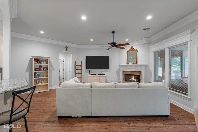 a living room with furniture a fireplace and a flat screen tv
