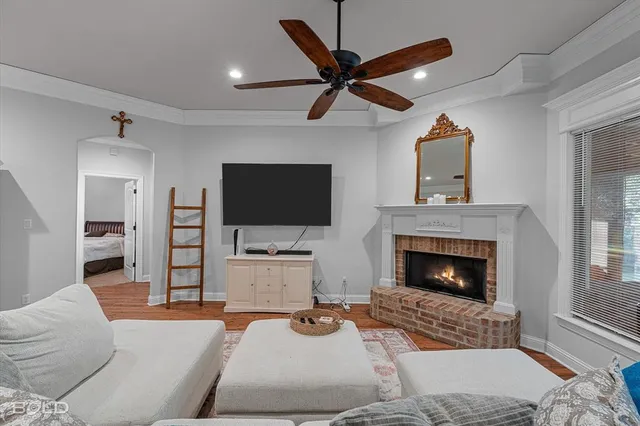 a living room with furniture a flat screen tv and a fireplace