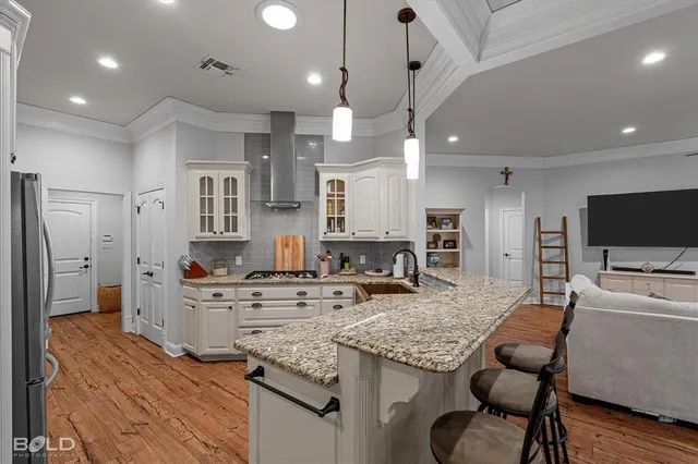 a kitchen with stainless steel appliances granite countertop a sink stove and refrigerator