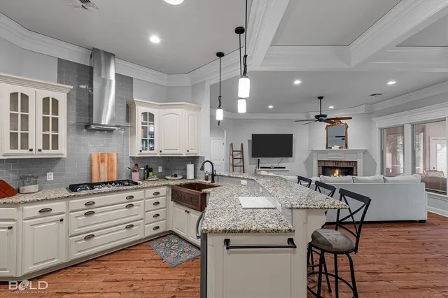 a kitchen with granite countertop a stove and cabinets