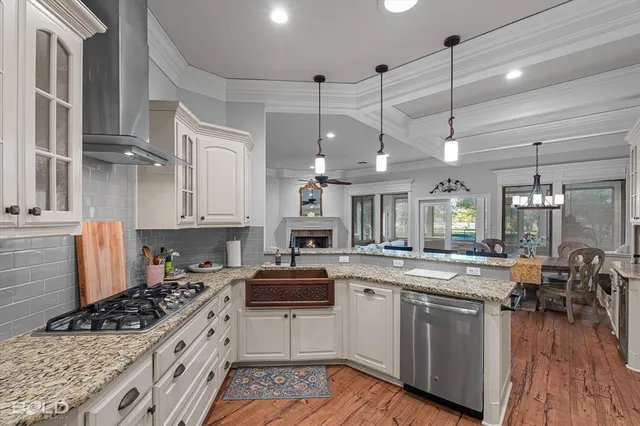 a kitchen with stainless steel appliances granite countertop a stove and cabinets