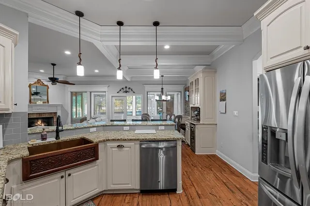 a kitchen with stainless steel appliances granite countertop a stove and refrigerator