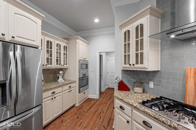 a kitchen with stainless steel appliances a refrigerator sink and cabinets