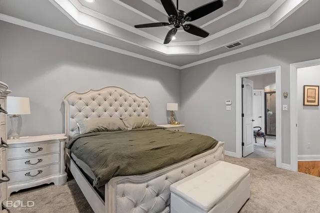 a bedroom with a large bed and a chandelier