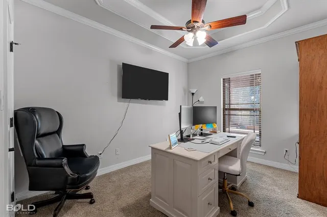 a work room with furniture and a flat screen tv