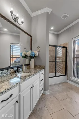 a spacious bathroom with a granite countertop sink a mirror and a shower
