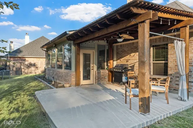 a view of a house with backyard porch and sitting area