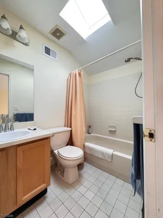 a bathroom with a sink toilet a mirror and shower