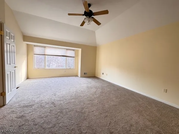 an empty room with a empty space and windows