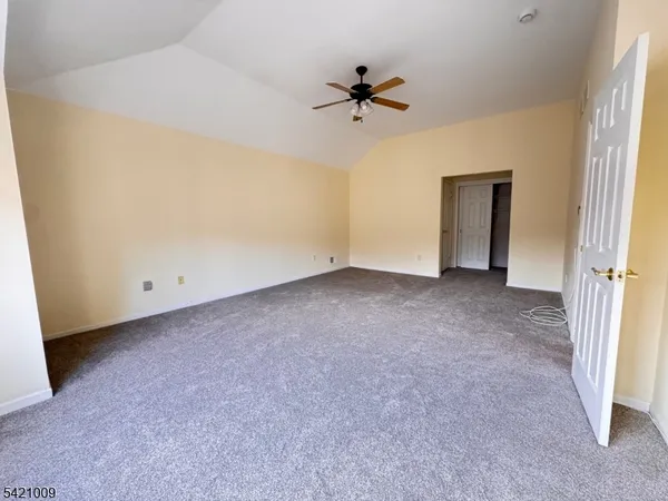 a view of room with a ceiling fan