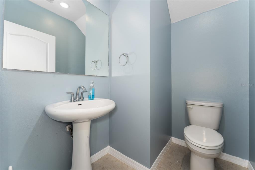 4331 Wayne Road Fruitland Park, FL 34731 - Photo 25 of 46 a bathroom with a sink a toilet and mirror