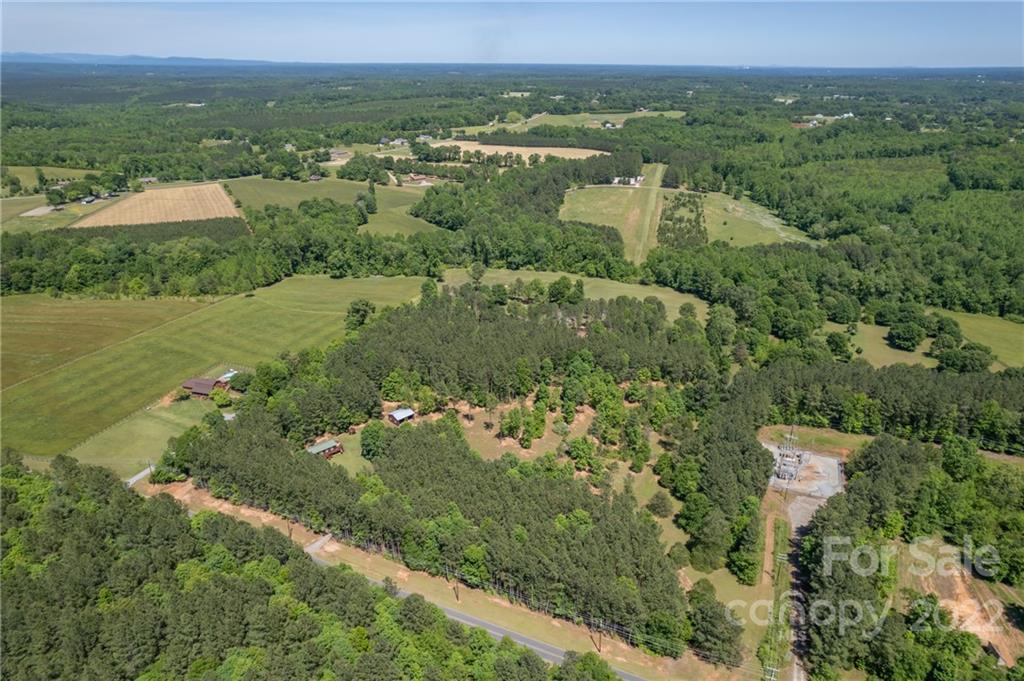 611 Mc Dowell Road Columbus, NC 28722 - Photo 23 of 39 an aerial view of green landscape with trees houses and mountain view