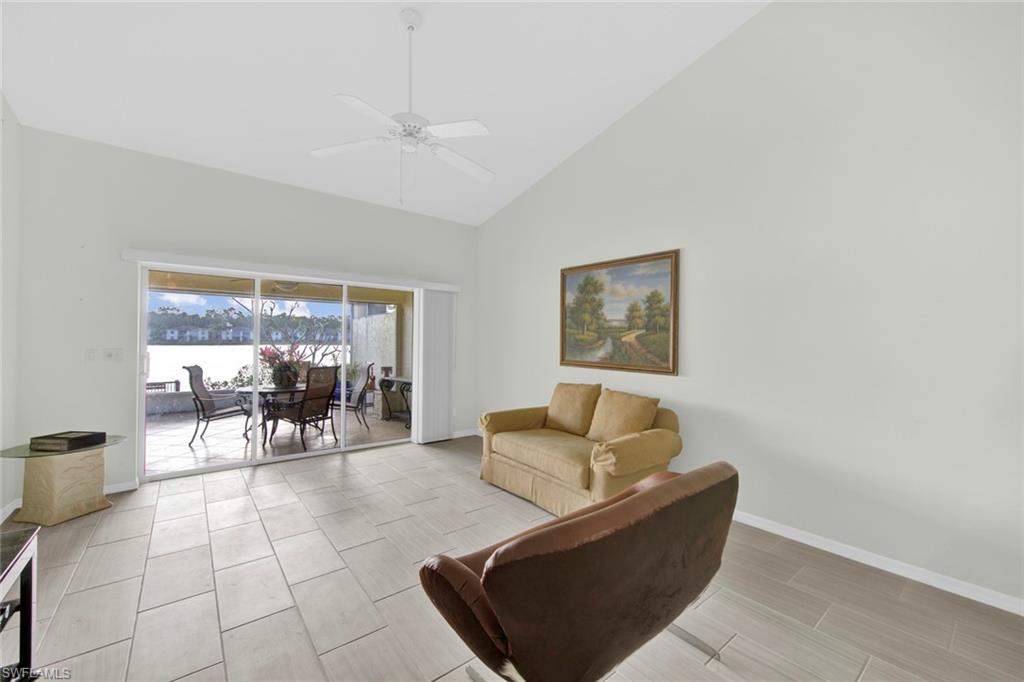 2912 West Crown Pointe Boulevard, Unit 141 Naples, FL 34112 - Photo 11 of 32 a living room with furniture and a dining table