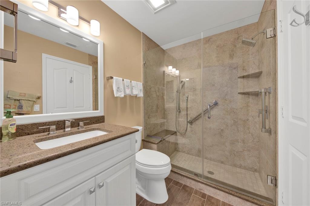 2912 West Crown Pointe Boulevard, Unit 141 Naples, FL 34112 - Photo 17 of 32 a bathroom with a sink a toilet and shower