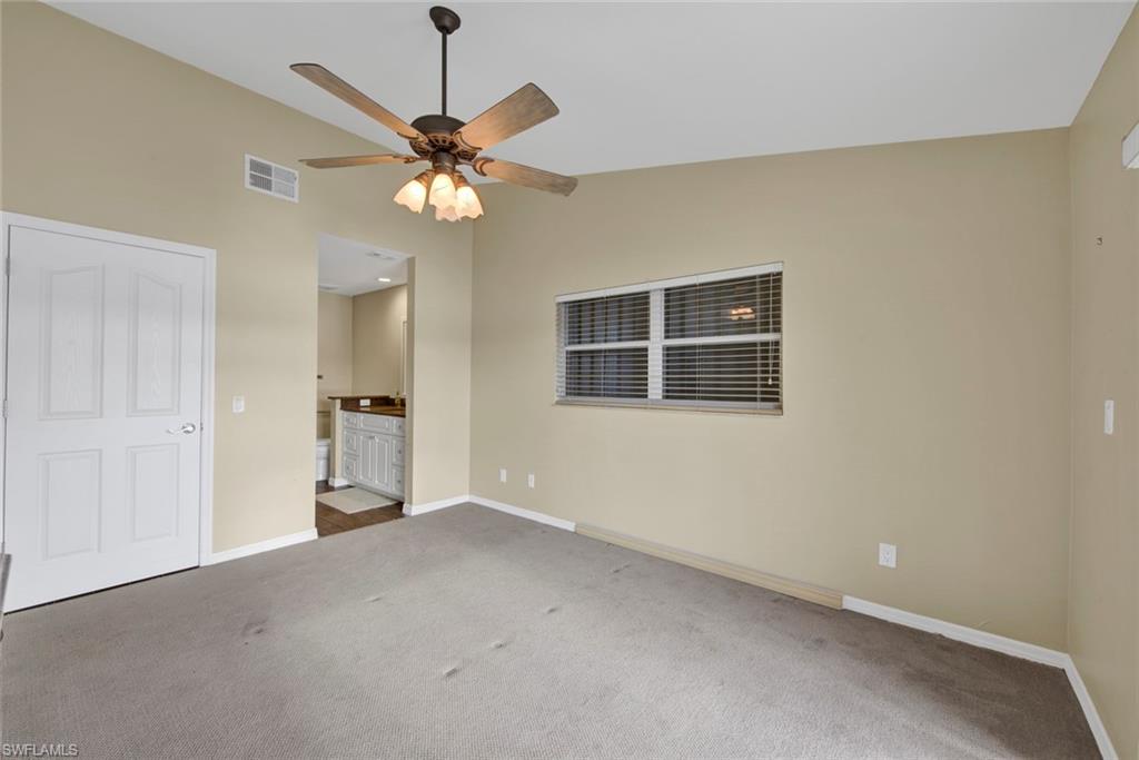 2912 West Crown Pointe Boulevard, Unit 141 Naples, FL 34112 - Photo 21 of 32 a view of a livingroom with a ceiling fan and a window