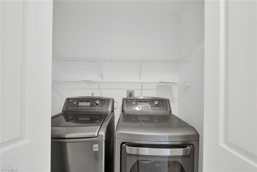 2912 West Crown Pointe Boulevard, Unit 141 Naples, FL 34112 - Photo 24 of 32 a utility room with dryer and washer