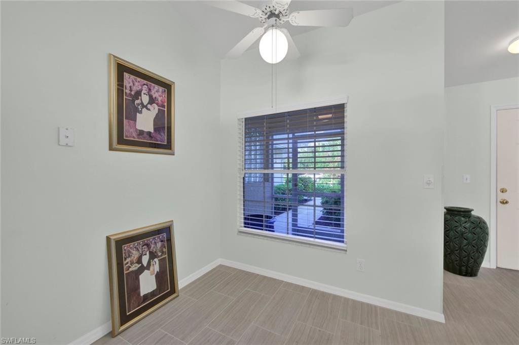 2912 West Crown Pointe Boulevard, Unit 141 Naples, FL 34112 - Photo 3 of 32 an empty room with windows and fan