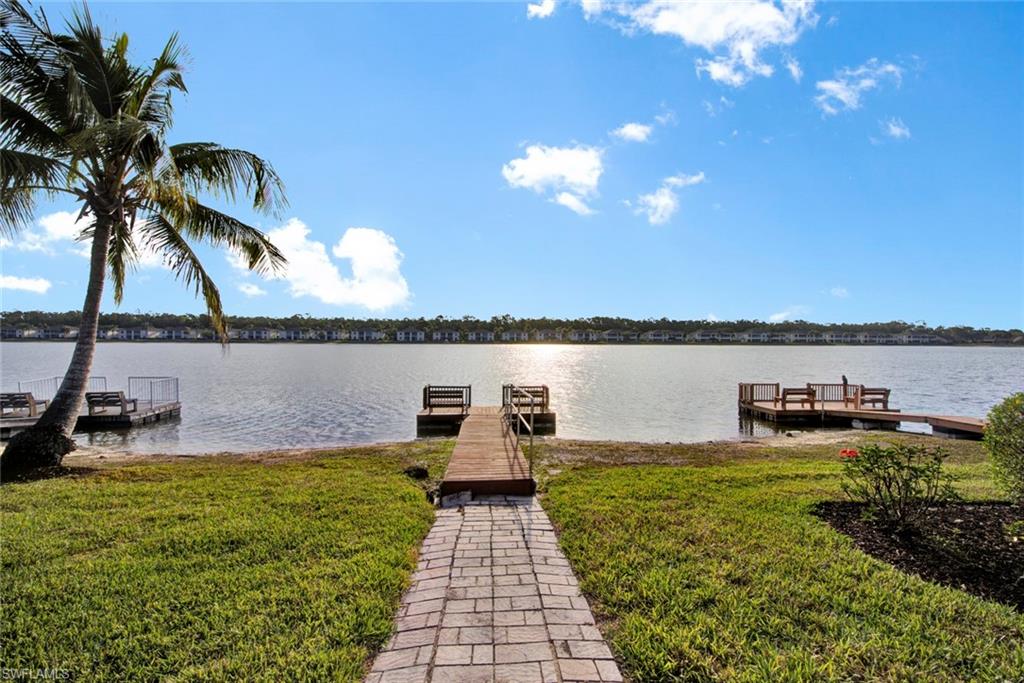 2912 West Crown Pointe Boulevard, Unit 141 Naples, FL 34112 - Photo 31 of 32 a view of a lake with houses in the back