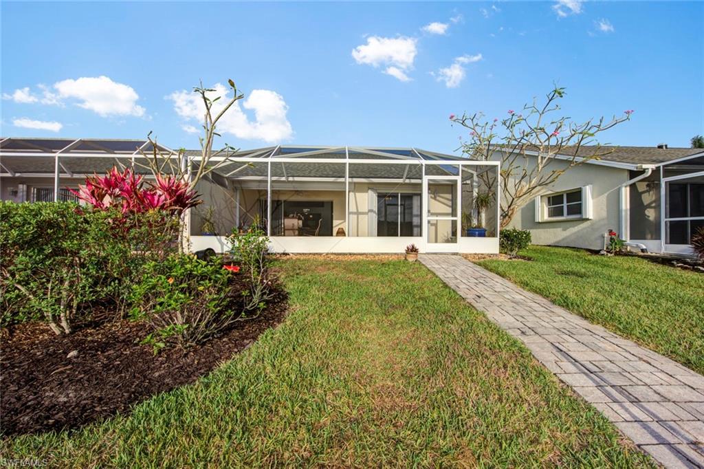 2912 West Crown Pointe Boulevard, Unit 141 Naples, FL 34112 - Photo 32 of 32 front view of a house with a yard