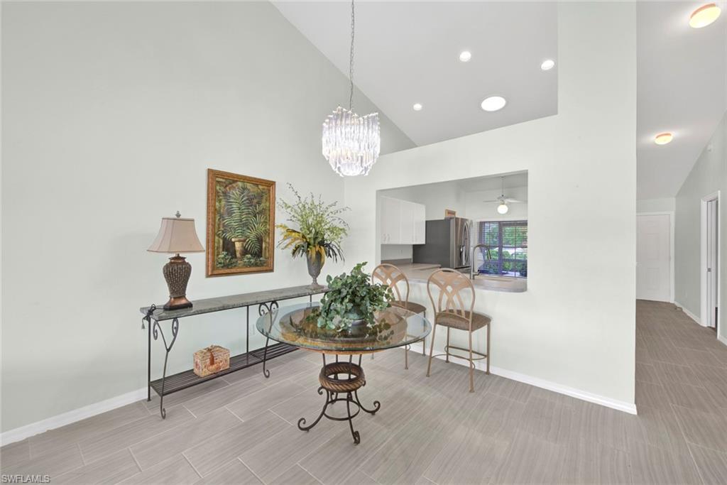2912 West Crown Pointe Boulevard, Unit 141 Naples, FL 34112 - Photo 10 of 32 a view of a livingroom with furniture and a potted plant