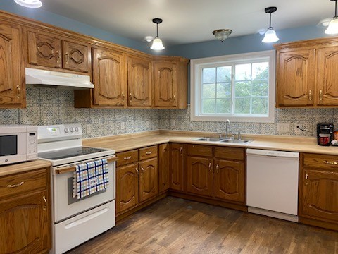 234 Alsup Road Prospect, TN 38477 - Photo 8 of 38 a kitchen with stainless steel appliances granite countertop a stove a sink dishwasher and cabinets with wooden floor