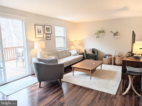 a living room with furniture a rug and a book shelf