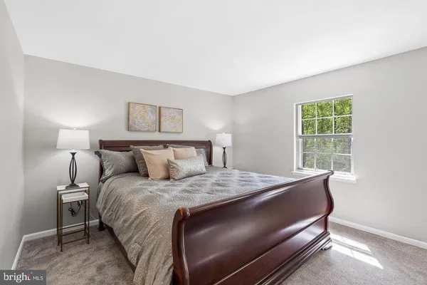 a bedroom with a large bed and furniture