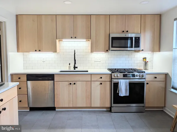 a kitchen with a refrigerator a sink and a stove