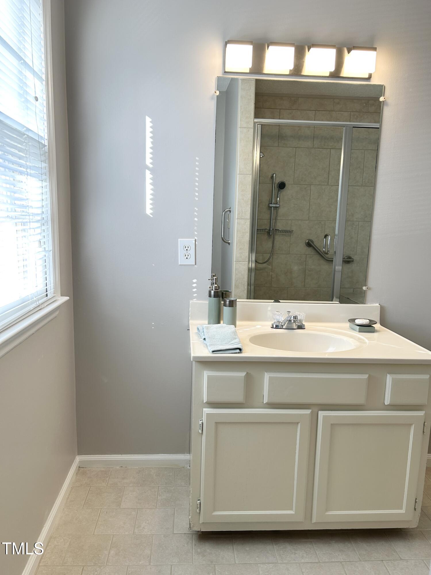 7341 Sweet Bay Lane Raleigh, NC 27615 - Photo 23 of 28 Renovated bath: new light fixture, ceramic tile floors, walk in shower