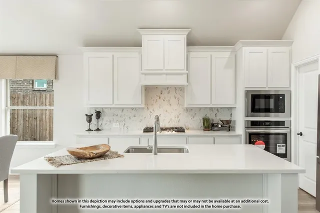 a kitchen with stainless steel appliances granite countertop a sink a stove and a microwave
