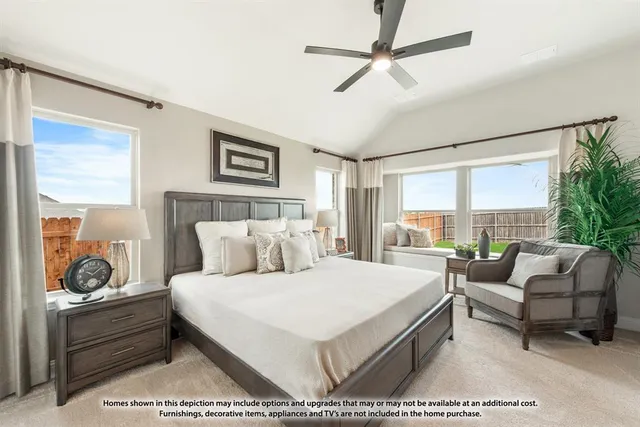 a bedroom with a bed a couch and a large window