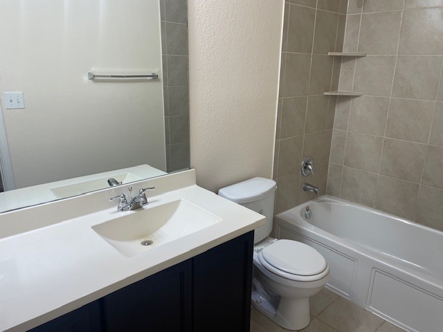 10201 Gertrudis Loop Austin, TX 78747 - Photo 20 of 24 A well-appointed bathroom features a sleek vanity, mirror, and tiled shower area with a bathtub.