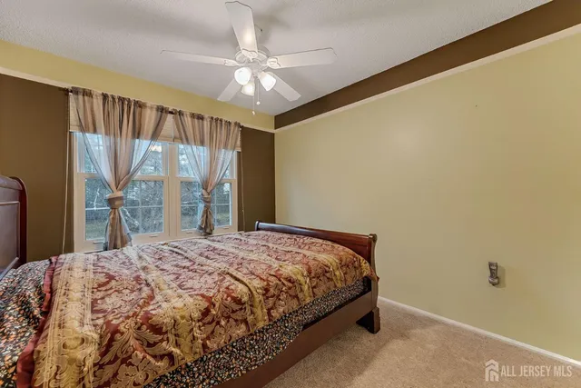 a bedroom with a large bed and a chandelier