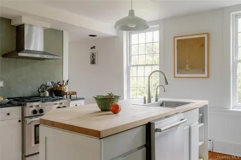 a kitchen with stainless steel appliances a stove a sink and a microwave