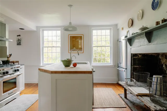 a view of a hallway with wooden floor and a dining table