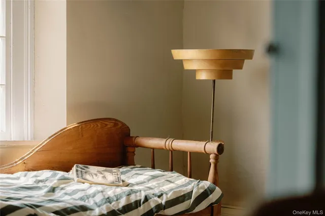 a bed sitting in a bedroom next to a window