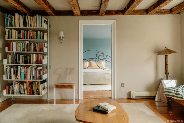 a living room with a book shelf and a book shelf