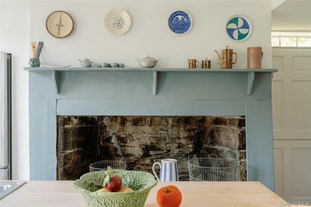 a kitchen with a refrigerator and wooden floor