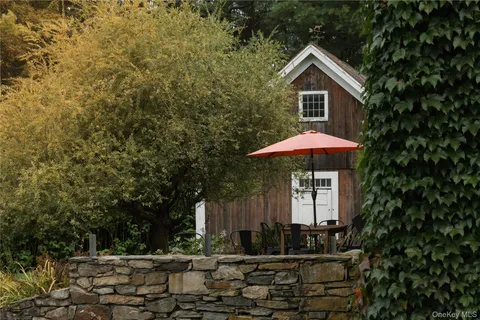 a front view of house with yard and trees
