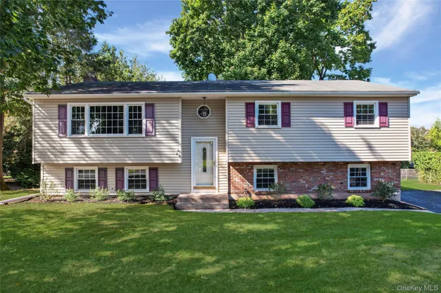 a front view of house with yard and green space