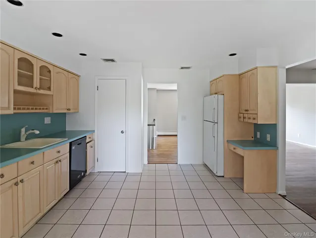a view of kitchen with furniture and refrigerator