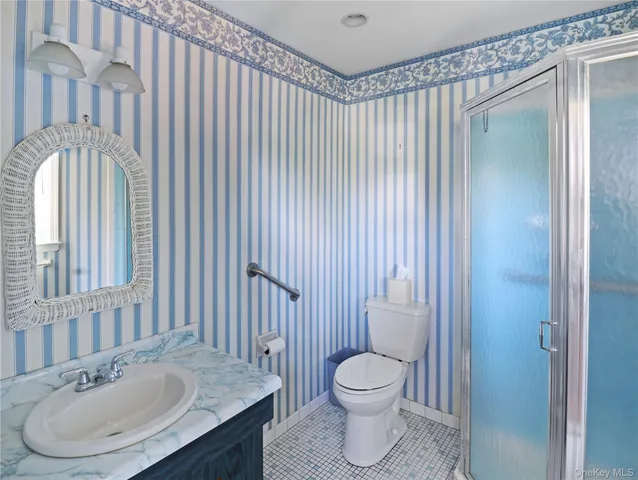 a view of an empty room with wooden floor and closet