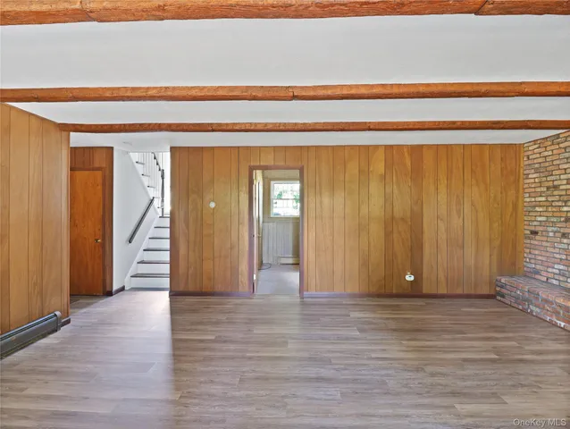a view of a hall with wooden floor