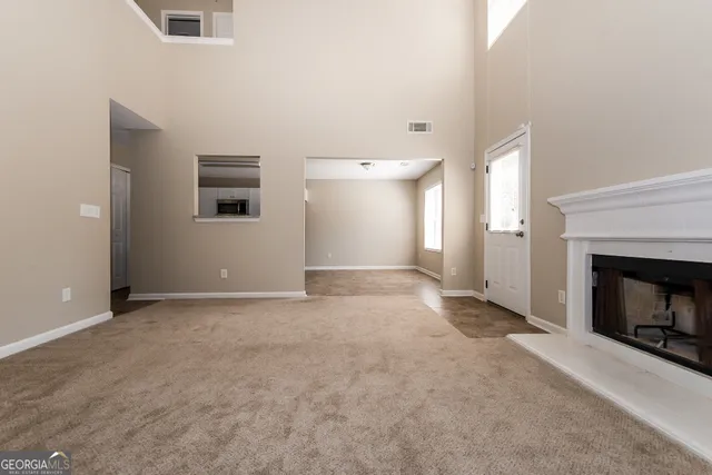 a view of empty room with a fireplace